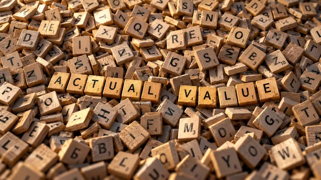 Letter tiles spelling Actual Value among a jumble of other letters.